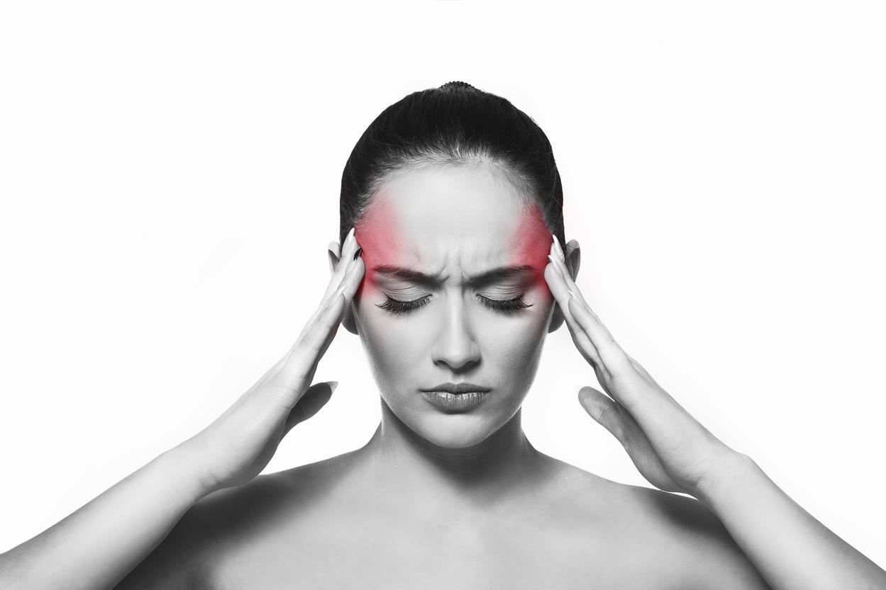 Woman in pain with headache holding her head
